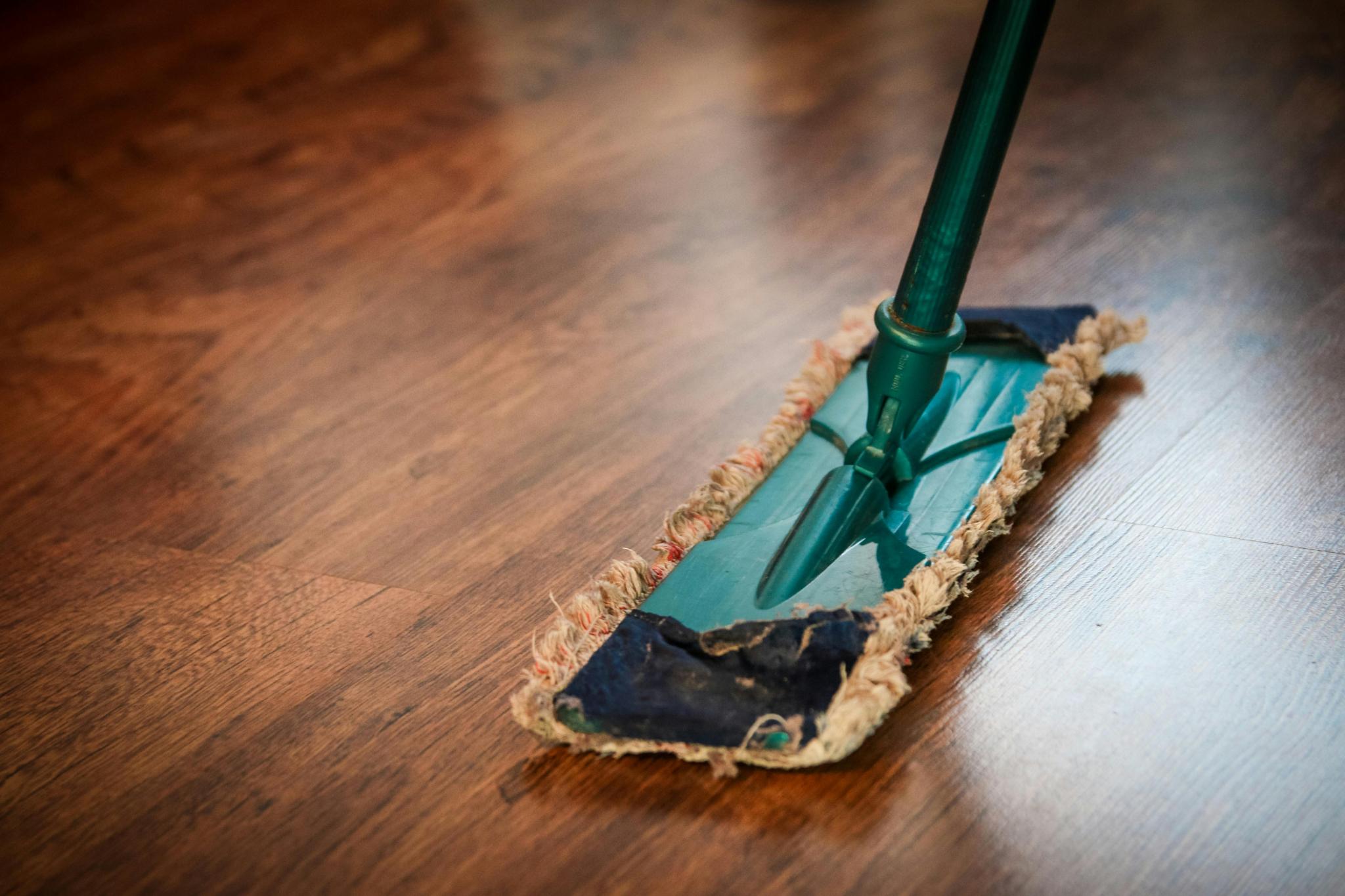 Dusting a gleaming hardwood floor