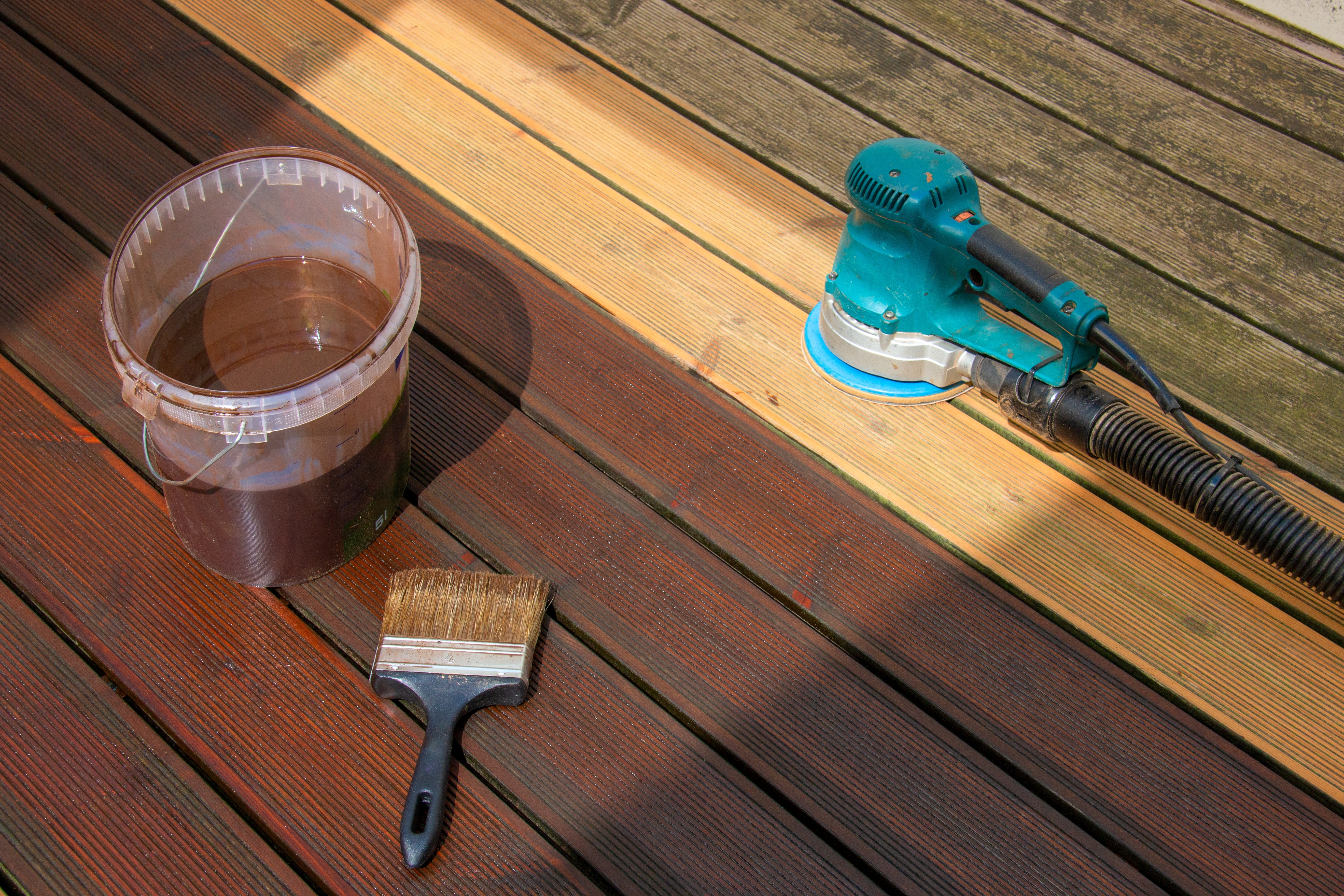 hardwood deck with stained and staining, sanded and sanding and untouched sections